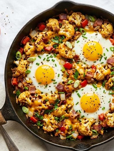 One-Skillet Loaded Cauliflower Hash with Baked Eggs & Cheddar